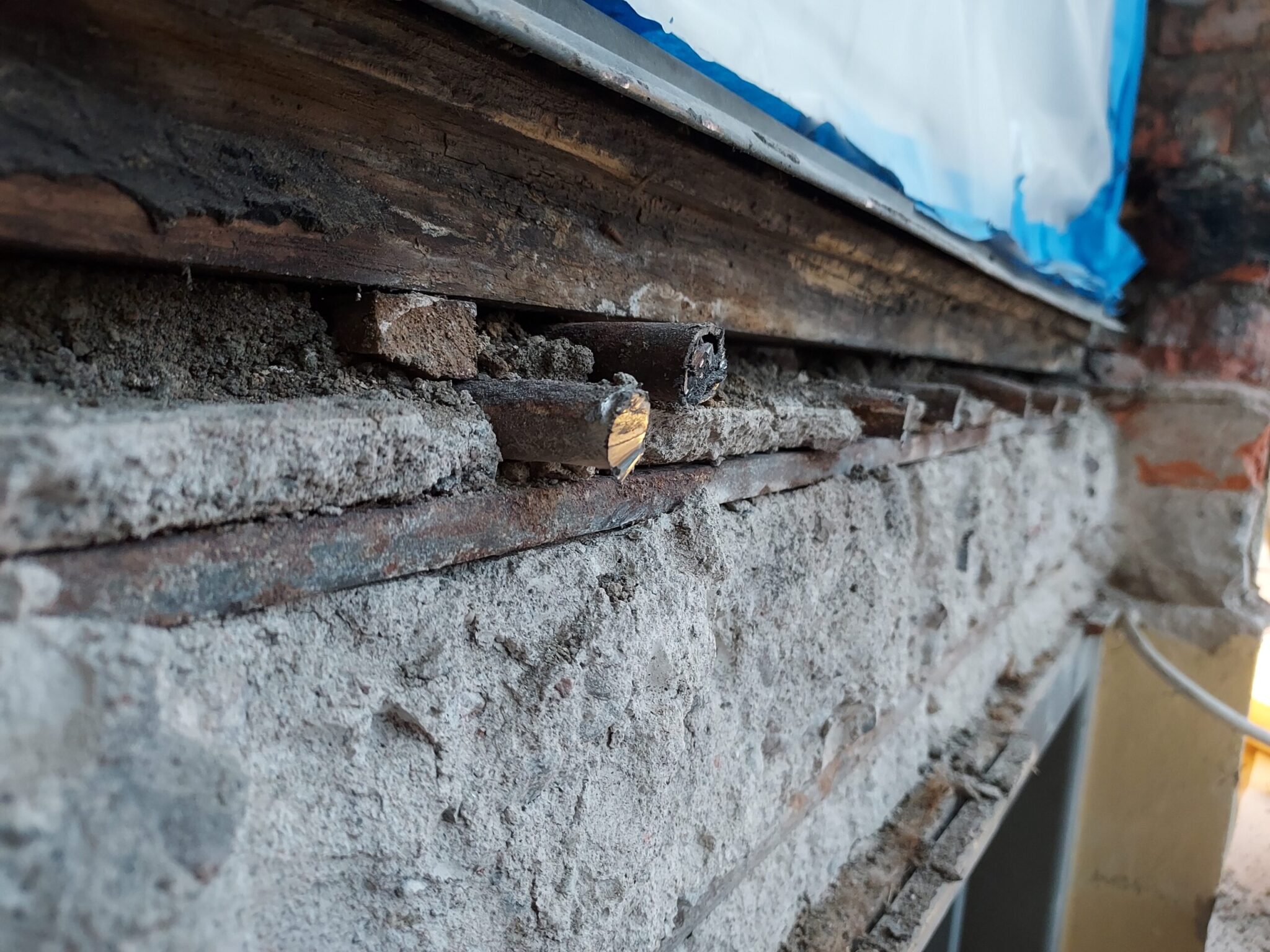 Close-up of a rough structural foundation with wooden supports and concrete — symbolizing online business maintenance and stability.