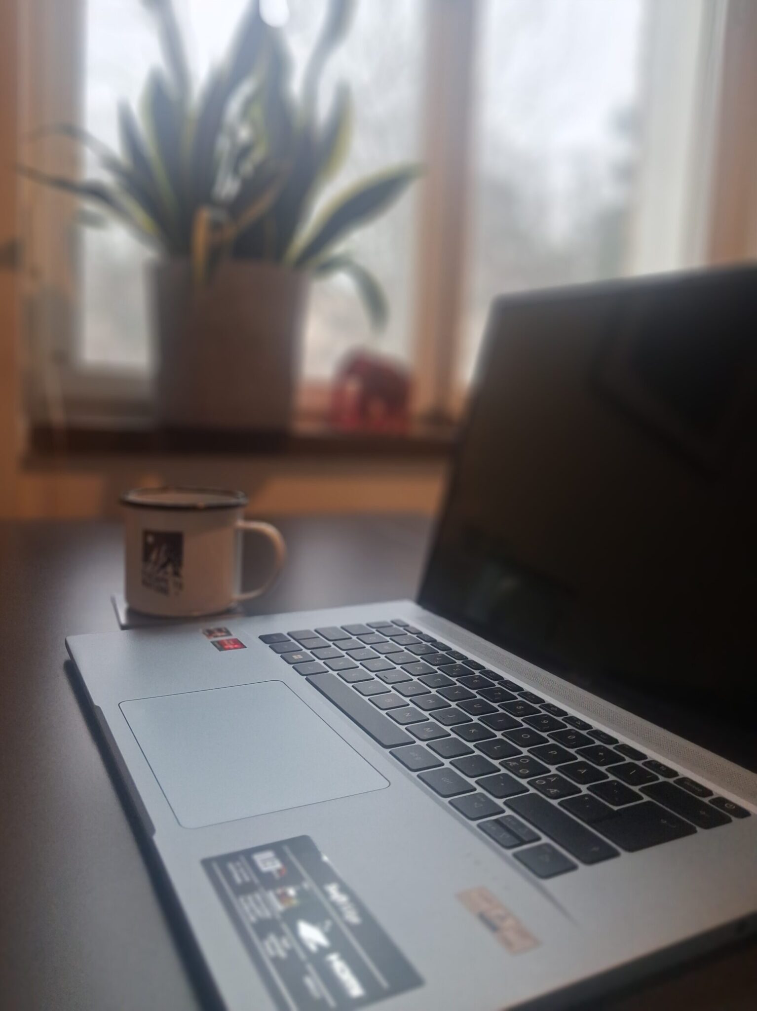 Laptop on desk in a home workspace for creating simple digital products