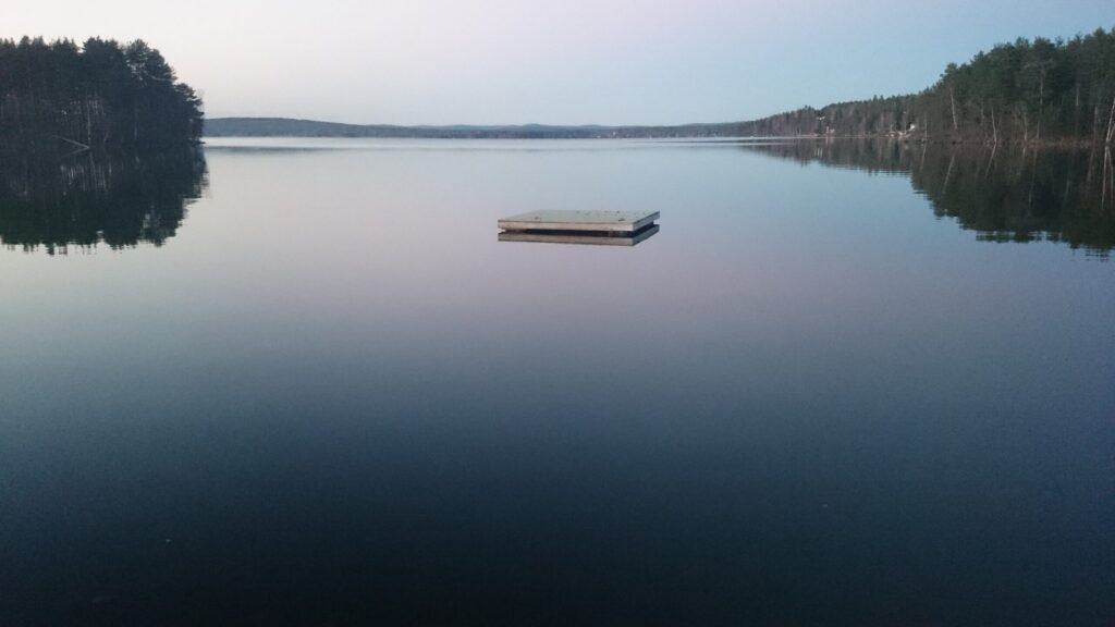 Floating dock on a calm lake at dusk, symbolizing long-term growth and the blogging journey.